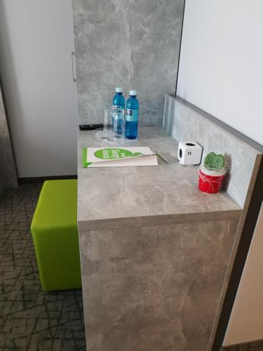 two bottles of water sitting on top of a counter at SleepySleepy Hotel Dillingen in Dillingen an der Donau