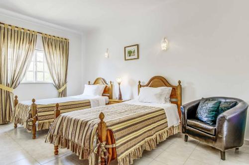 En eller flere senge i et værelse på Villa Torcato