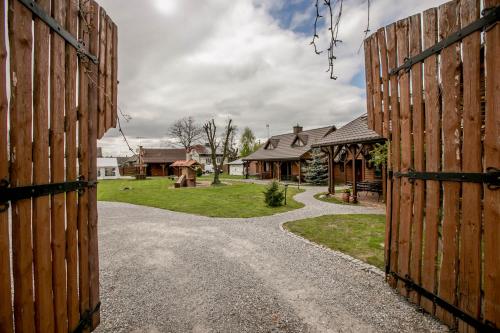 an entrance to a house with a wooden gate at Bocianówka in Baranów Sandomierski