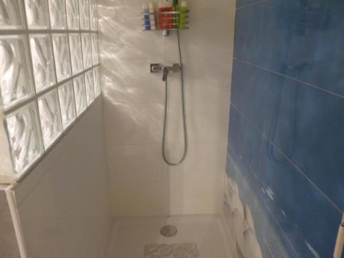 a bathroom with a shower with a shower head at Chambres d'Hôtes La Rose des Vents in Ginestas
