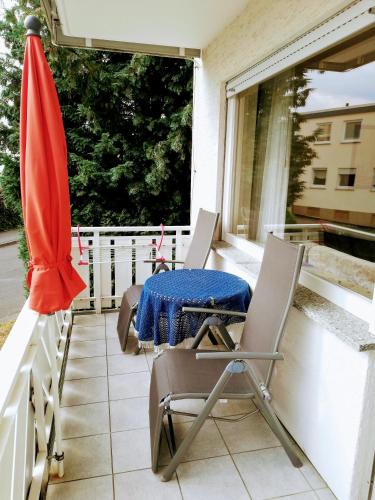 a patio with a table and chairs on a balcony at Haus Royal in Bad Wildungen