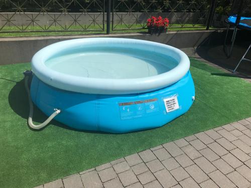 a large blue bath tub sitting on the grass at Willa Stenia Center Apartamenty in Wisła