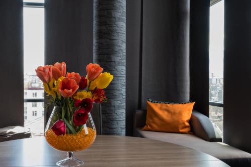 a vase of flowers sitting on top of a table at Budapest Hotel - Free Parking in Sofia