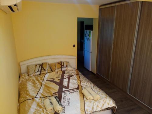 a bedroom with a bed and a refrigerator at Studio Lux in Pleven
