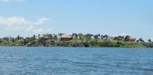a large body of water with a house on an island at Samuka Island Retreat in Jinja