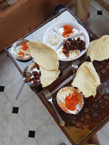 a table with plates of food on top of it at Kashmir View group of Houseboat in Srinagar