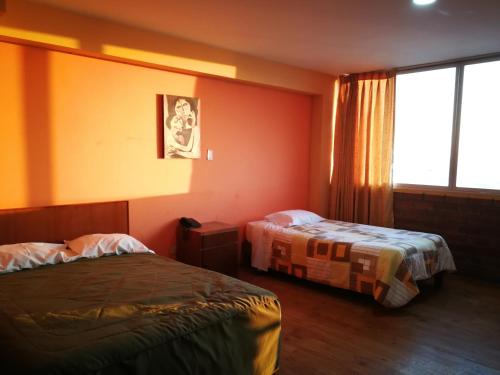 a hotel room with two beds and a window at Meflo Playa Grande in Chala