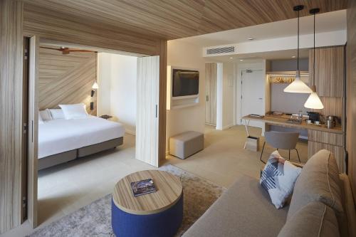 a hotel room with a bed and a desk at Bordoy Alcudia Port Suites - Adults Only in Port d'Alcudia