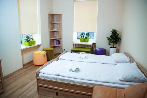 a bedroom with a large bed in a room at Coin Apartments & Poshtel in Chernivtsi