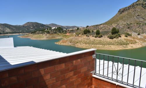 a view of a river with mountains in the background at Iznájar Suites in Iznájar
