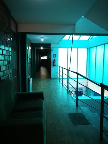 a hallway of a building with a couch and a railing at Meflo Playa Grande in Chala