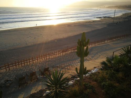 a view of a beach with chairs and a fence at Meflo Playa Grande in Chala