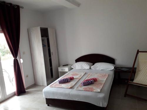 a bedroom with a bed with two pillows on it at Apartmani Andrea-jaz in Budva