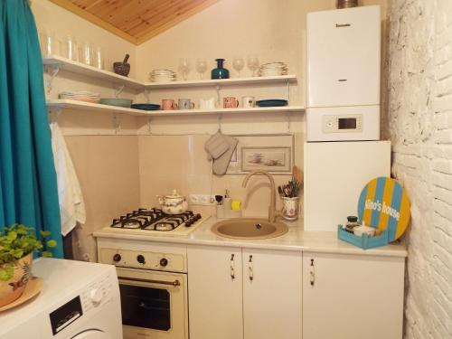 a small kitchen with a sink and a stove at Nino's House in Tsinandali