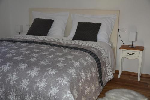 a bedroom with a large bed with two pillows at Pr' Koritnek in Bled