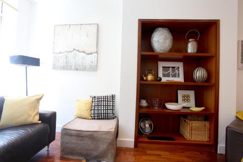 a living room with a couch and a book shelf at Park Row Apartments in Leeds