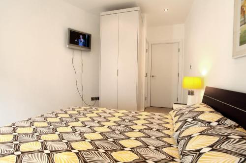 a bedroom with a bed and a tv on the wall at Park Row Apartments in Leeds