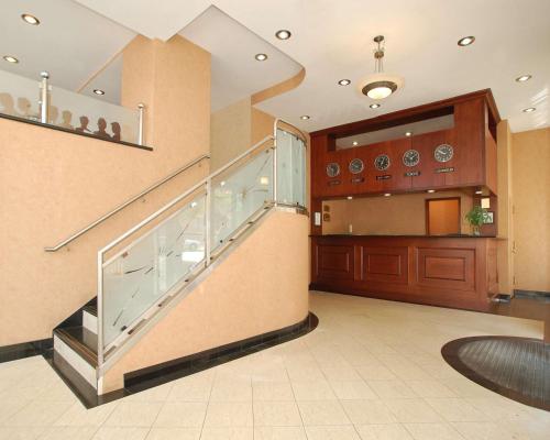 a lobby with a staircase in a building at Red Lion Inn & Suites Long Island City in Queens