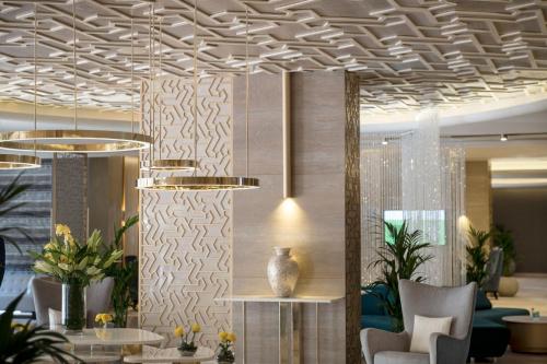 a lobby with a ceiling with a chandelier at Two Seasons Hotel & Apartments in Dubai