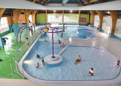 a group of people in an indoor swimming pool at New Forest Lodges Bashley Park in New Milton