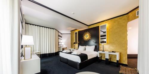 a hotel room with a large bed and a mirror at Aurea Fatima Hotel Congress & Spa in Fátima