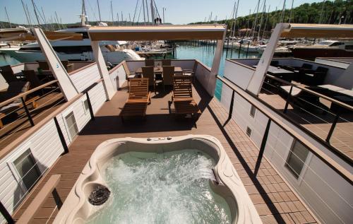 a hot tub on the deck of a boat at Floating Sea Houses MARINA LUX in Portorož