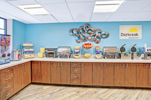 a food counter at adqapp restaurant with a blue wall at Days Inn & Suites by Wyndham Page Lake Powell in Page