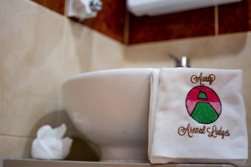 a towel on a sink in a bathroom at Aunty Arenal Lodge in Fortuna