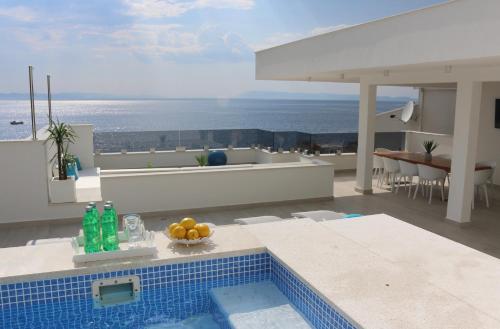 a house with a swimming pool with a view of the ocean at Villa Mel II in Drasnice