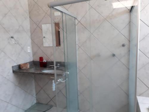 a bathroom with a sink and a shower at Pousada Jasmine in João Pessoa