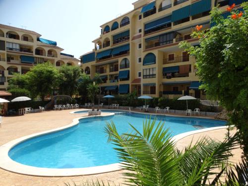 a large swimming pool in front of a building at Apartment Blanco - Vina Mar III in La Mata