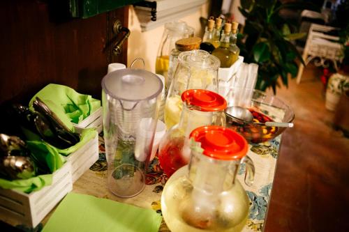 a table with many glass jars on top of it at Domus Socolatae Residenza d'Epoca Charming B&B - Adults Only in Follonica