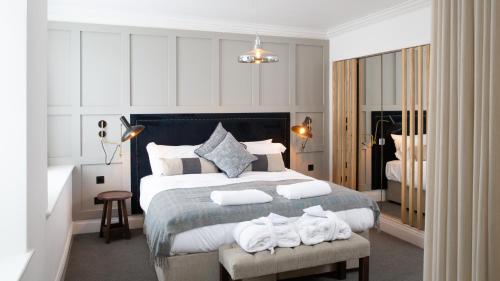 a bedroom with a large bed with towels on it at The Black Bull Inn in Sedbergh