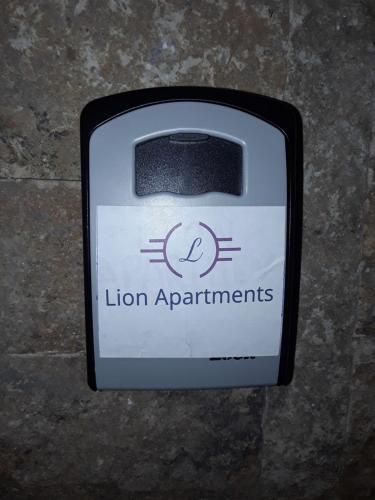 a black and white sign for lion apartments at Lion Apartment Sunset in Thessaloniki