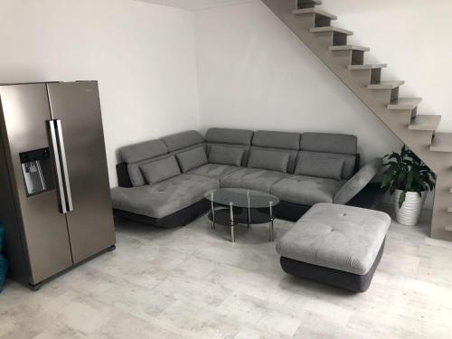 uma sala de estar com um sofá e um frigorífico em Luxusní apartmán přímo v centru u hotelu Thermal em Karlovy Vary