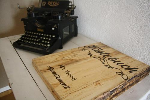 a cake sitting on a table next to a typewriter at M's Wood Appartement in Maishofen
