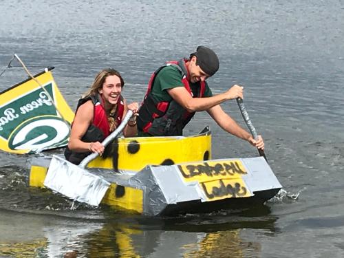 two people in a sail boat in the water at Lake Louise Lodge, Alaska in Glennallen