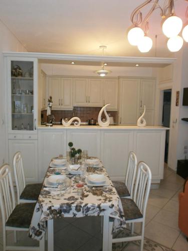 a kitchen with a table and chairs in a kitchen at Beach Front House With View in Marathos