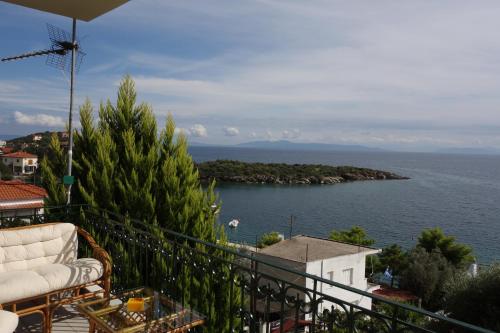 a balcony with a view of a body of water at Beach Front House With View in Marathos