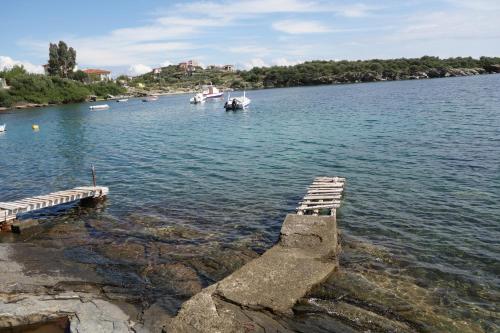 a body of water with boats in the water at Beach Front House With View in Marathos