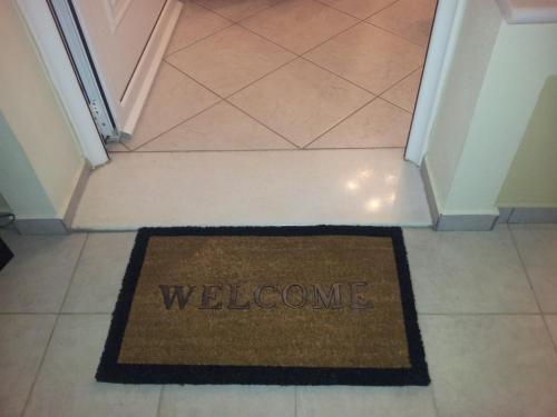 a welcome mat on the floor of a hallway at Beach Front House With View in Marathos