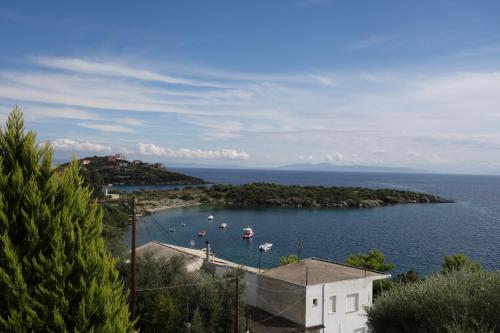 a small island in the water with boats in it at Beach Front House With View in Marathos