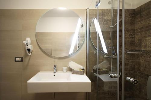 a bathroom with a sink and a mirror and a shower at Asseu in Sestri Levante