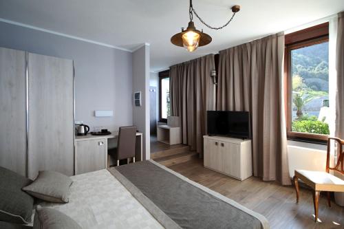 a bedroom with a bed and a desk and a television at Asseu in Sestri Levante