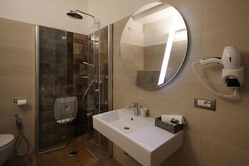 a bathroom with a sink and a shower and a mirror at Asseu in Sestri Levante