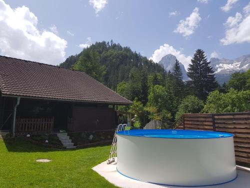 a hot tub in the yard of a house at Holzhaus in Hinterstoder in Hinterstoder