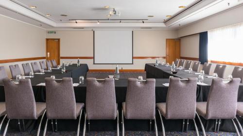 a conference room with a long table and chairs at Millennium Hotel Rotorua in Rotorua
