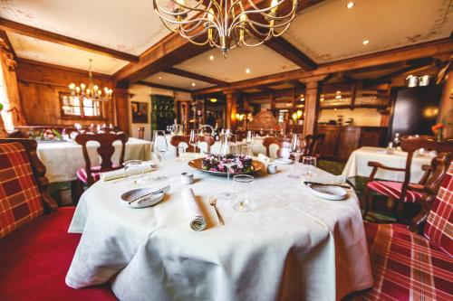 uma sala de jantar com uma mesa com toalha de mesa branca em Hotel Löwen em Eggenstein-Leopoldshafen