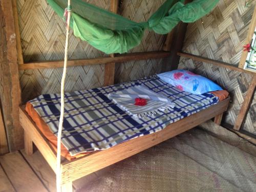 a bed in a room in a hut at Volcano Island Paradise Bungalows in Tanna Island