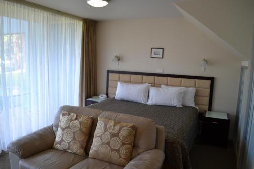 A bed or beds in a room at Lufra Hotel and Apartments